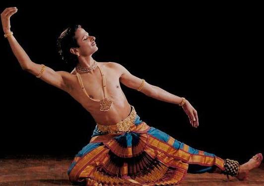 Kuchipudi dance performers on stage in a vibrant cultural presentation